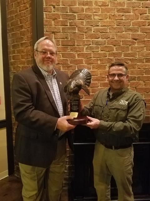 Bob Duncan, recognized for his 40 years of conservation service, stands next a National Wildlife Turkey Federation representative